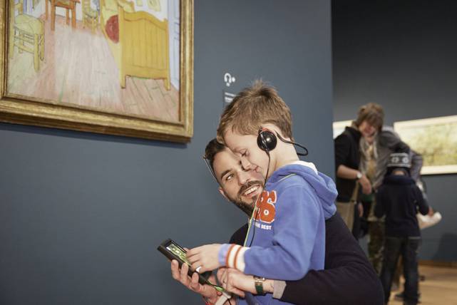 Father and son do the Van Gogh Museum tour in the museum